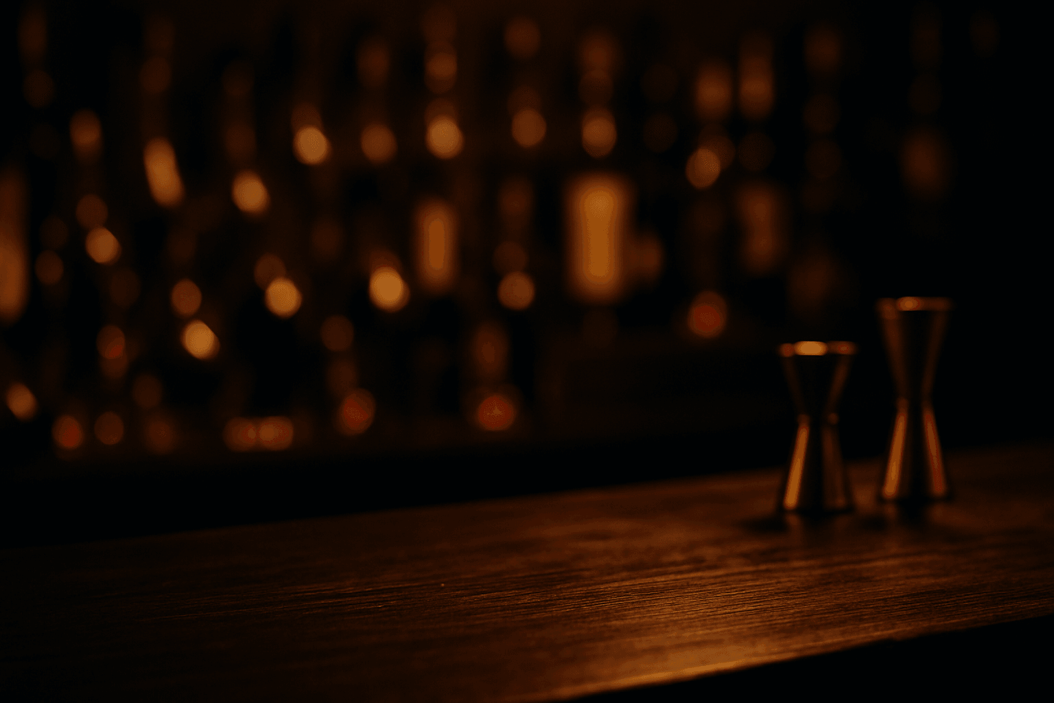 Premium bar atmosphere with amber-lit spirits bottles and crafted cocktails