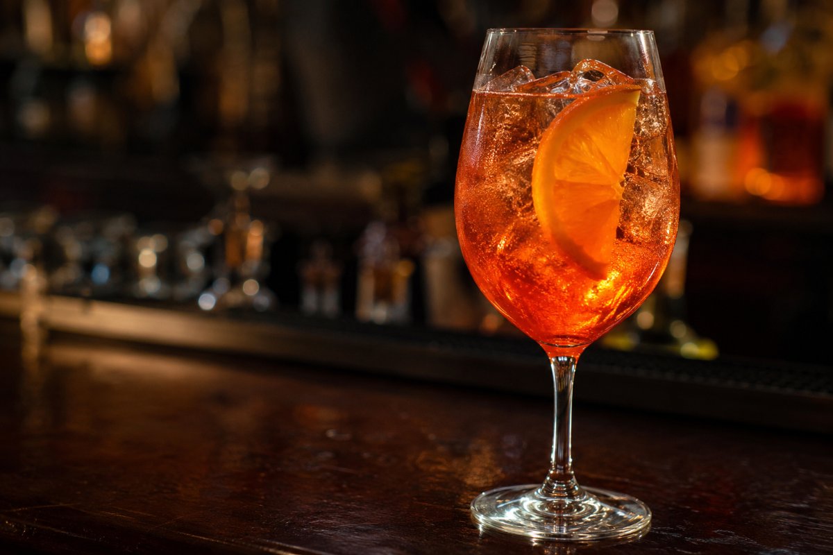 Aperol Spritz cocktail - aperitif-based served in a glass with garnish