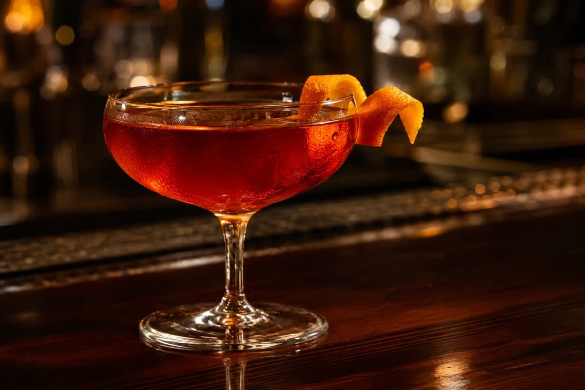 Blood and Sand cocktail - whiskey-based served in a glass with garnish
