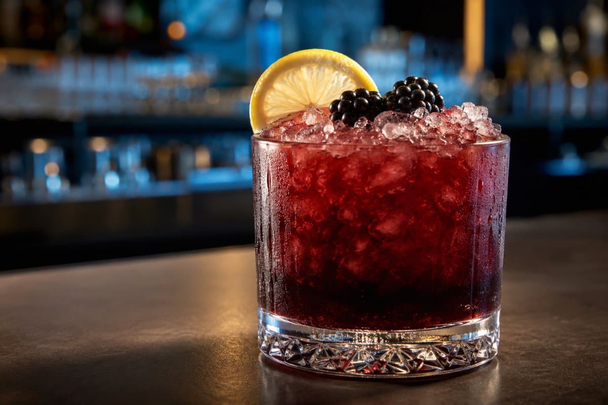 Bramble cocktail - gin-based served in a glass with garnish