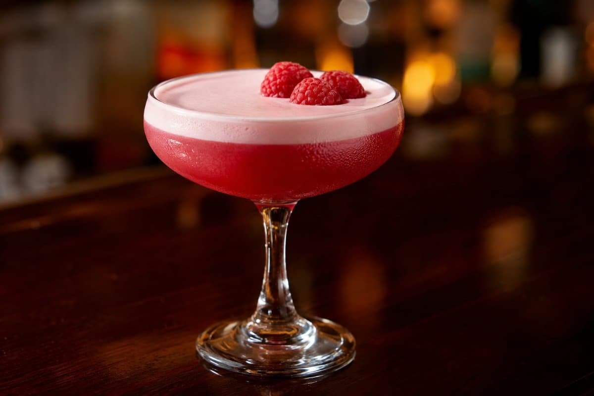 Clover Club cocktail - gin-based served in a glass with garnish