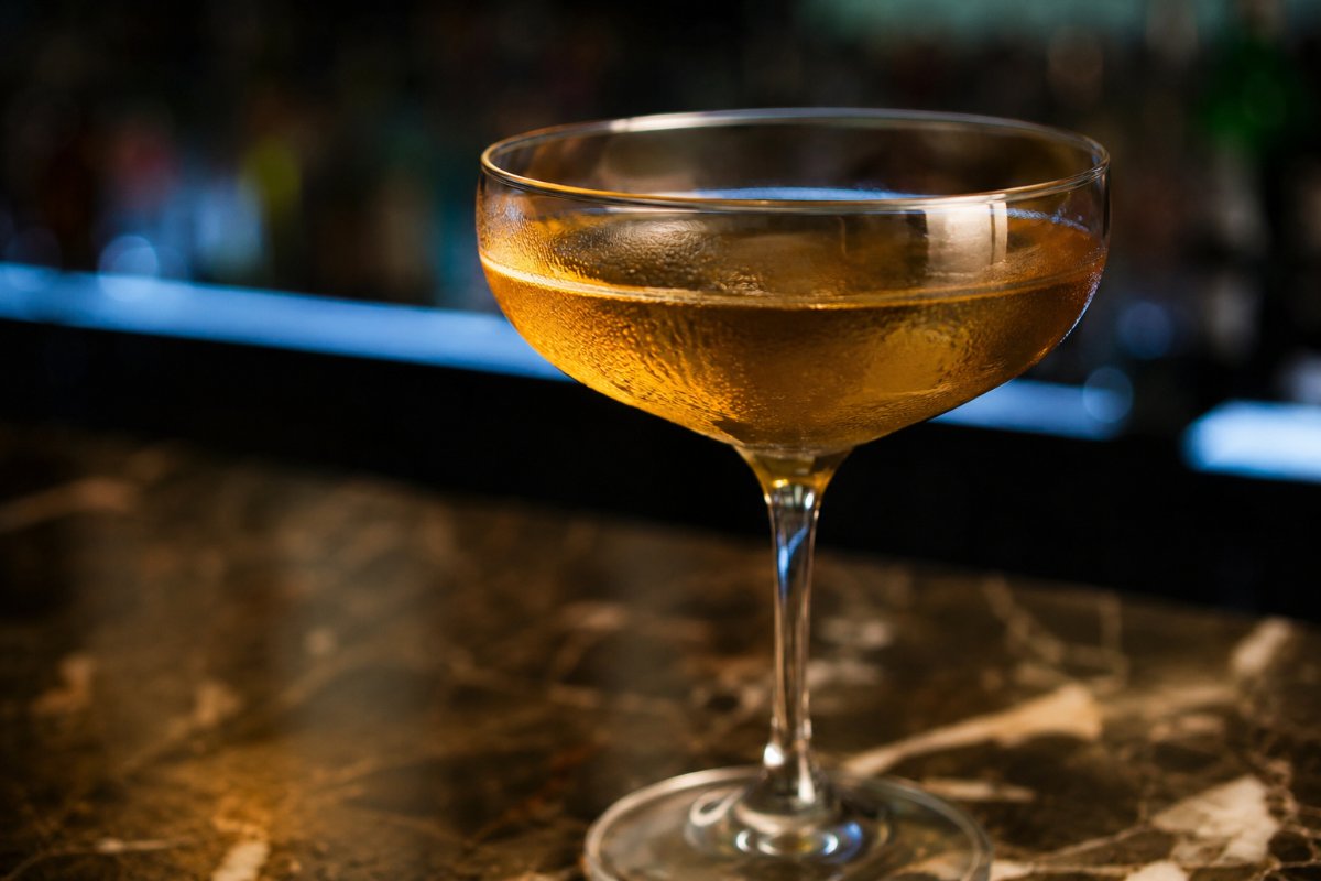Naked and Famous cocktail - mezcal-based served in a glass with garnish