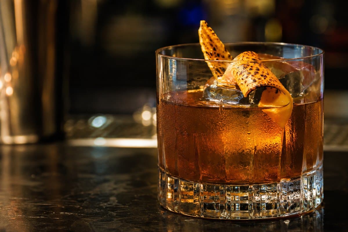 Oaxaca Old Fashioned cocktail - mezcal-based served in a glass with garnish