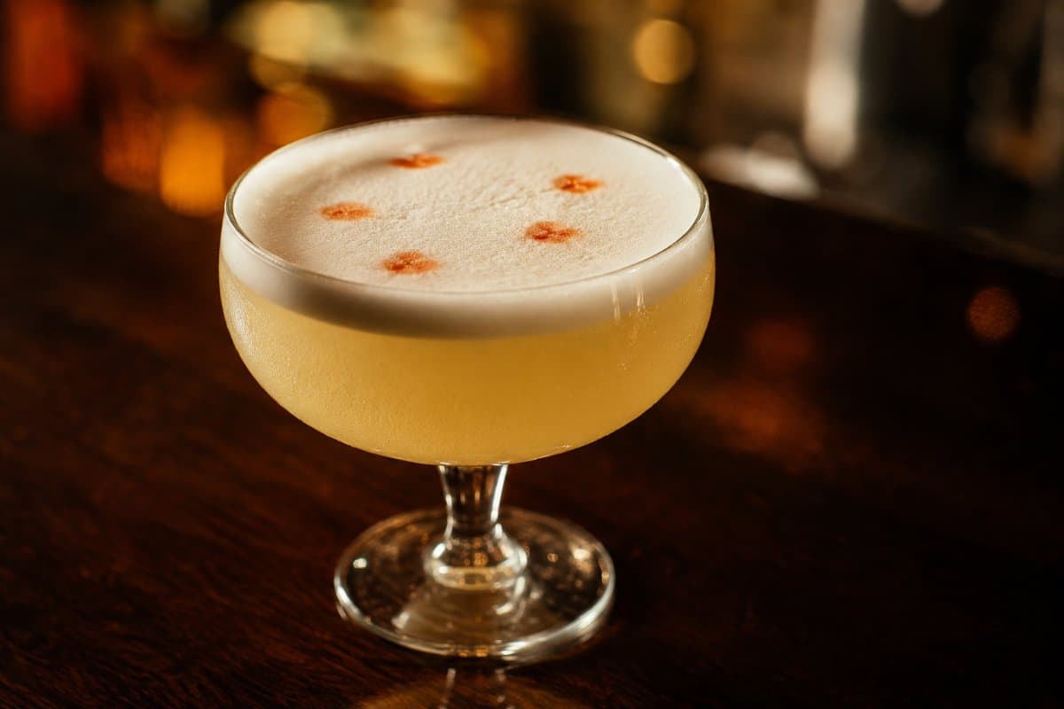 Pisco Sour cocktail - brandy-based served in a glass with garnish