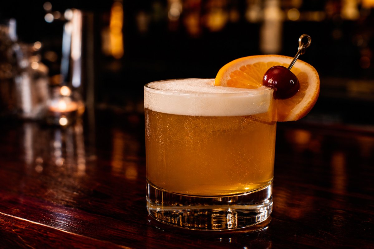 Whiskey Sour cocktail - whiskey-based served in a glass with garnish