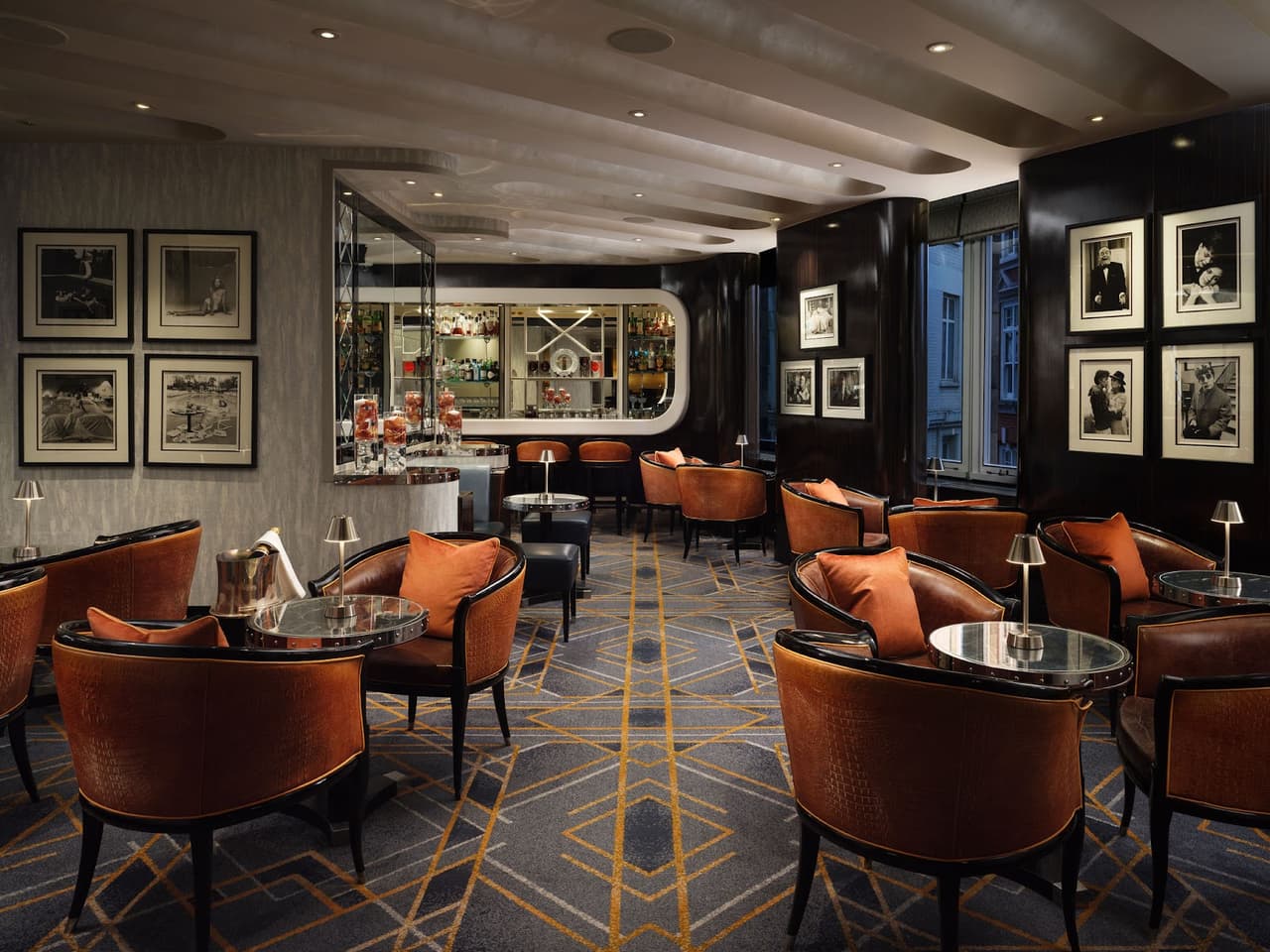 Sophisticated cocktail bar interior with elegant seating and artwork on walls