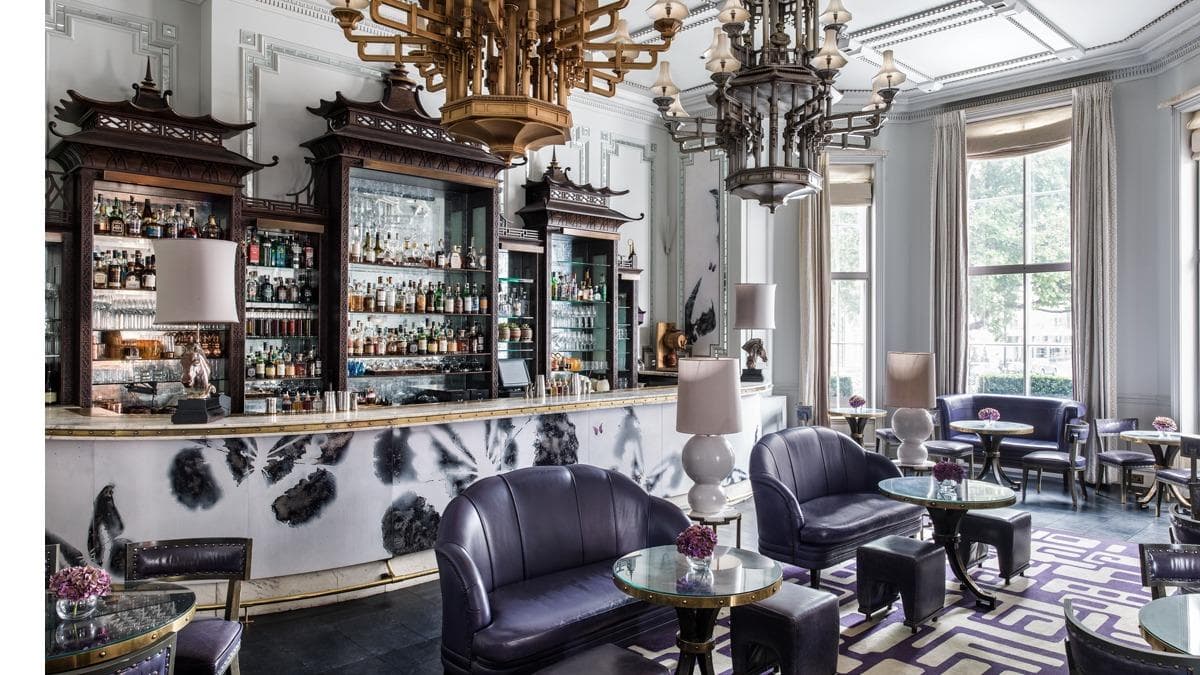 Elegant bar with plush seating and chandeliers in a classic setting
