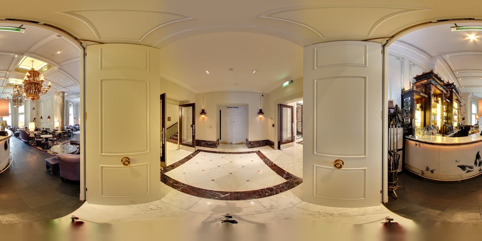 Elegant interior of a cocktail bar with chandeliers and marble floors in London