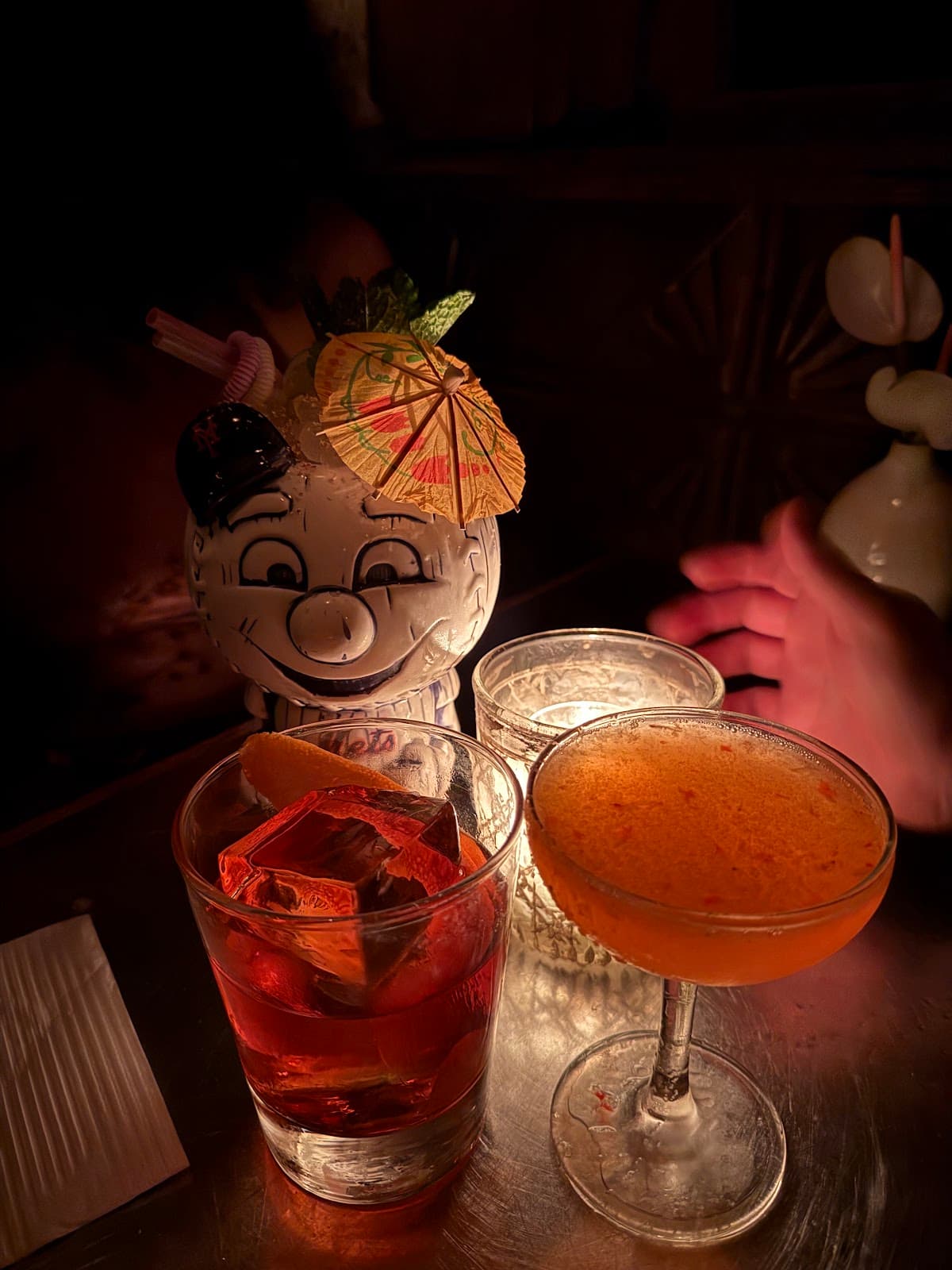 Close-up of cocktails on a dimly lit bar table in New York