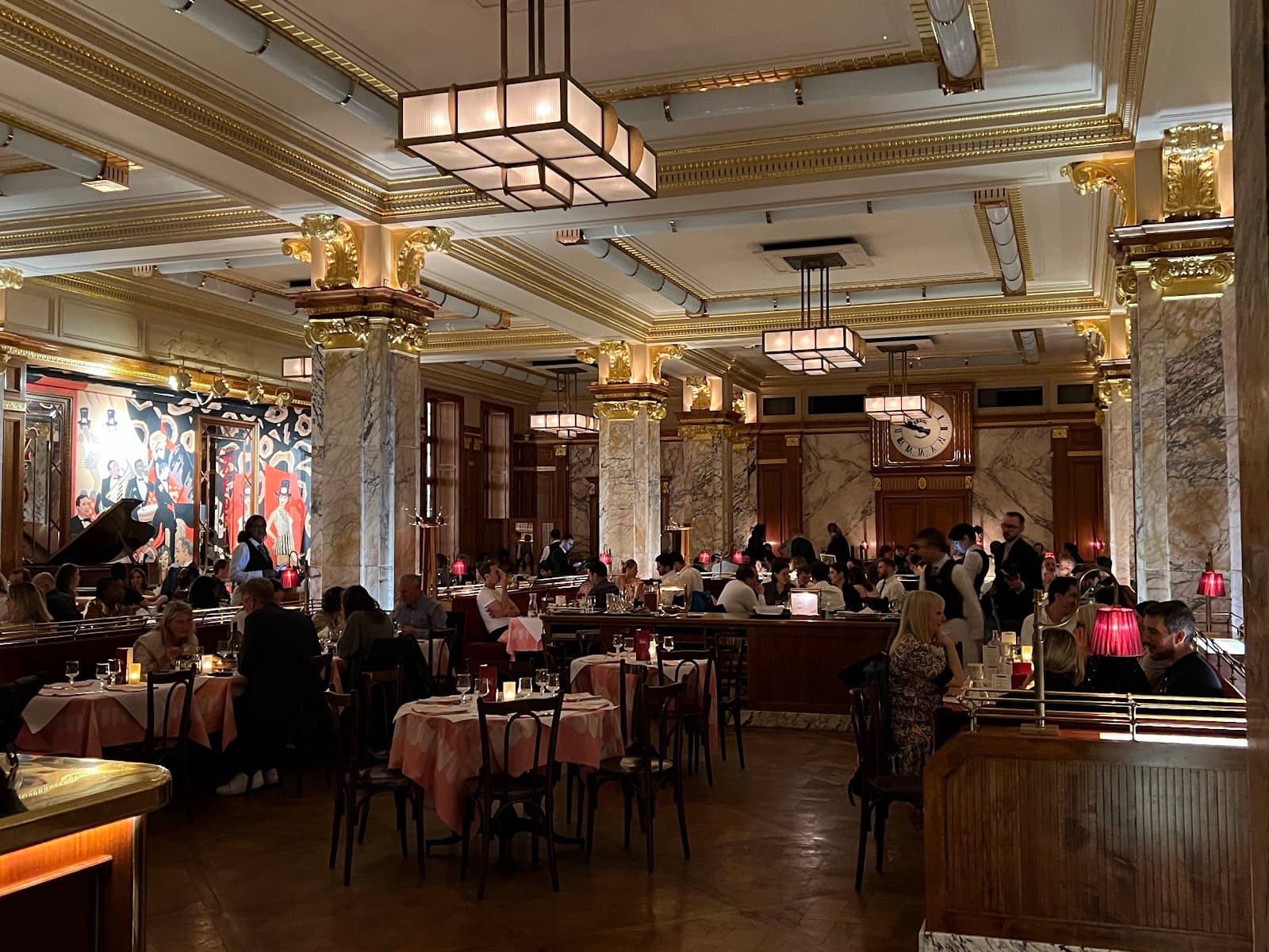Luxurious bar interior with ornate columns and dining patrons in London