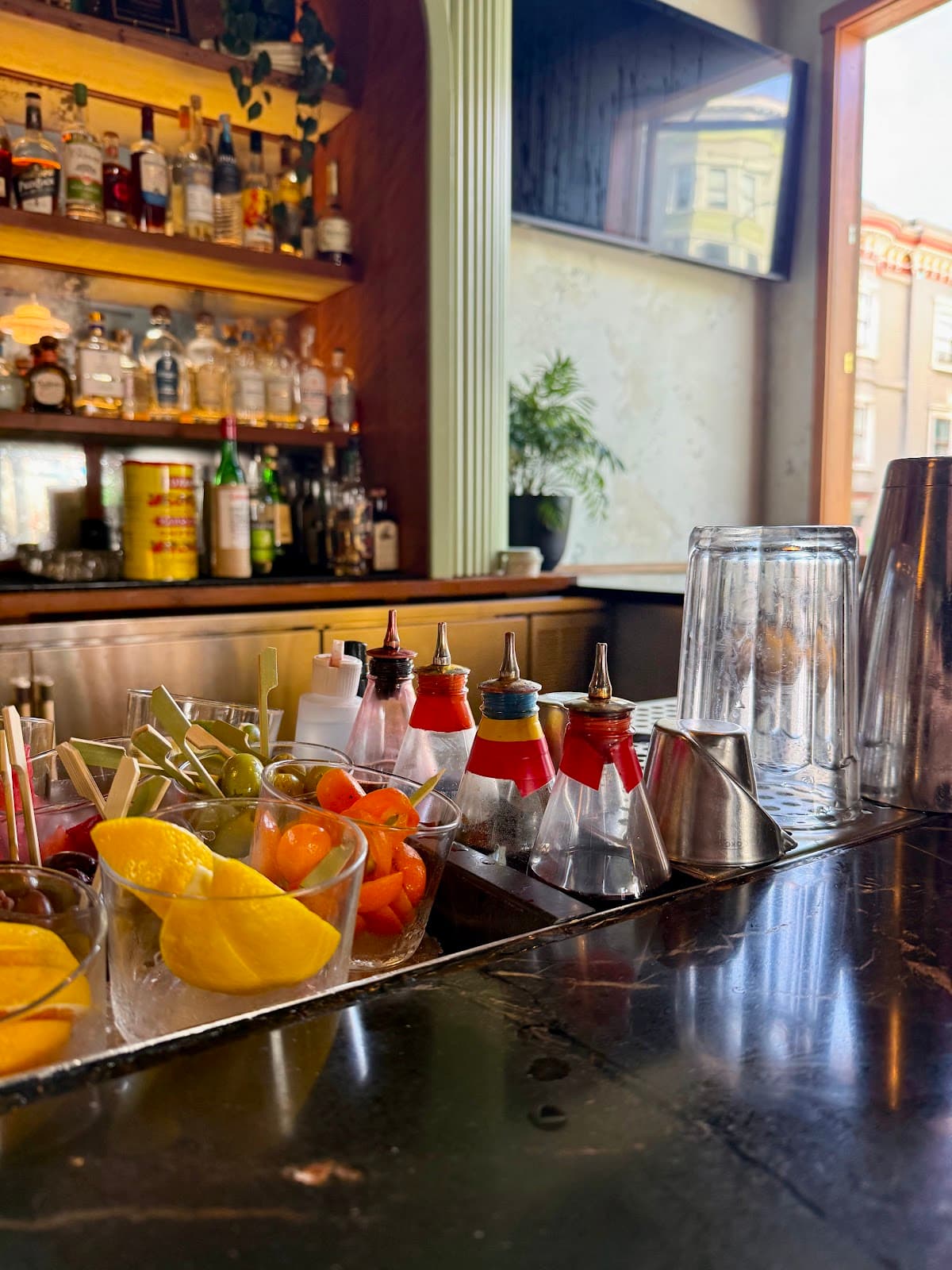 Close-up of a bar counter with cocktail garnishes and bottles in San Francisco