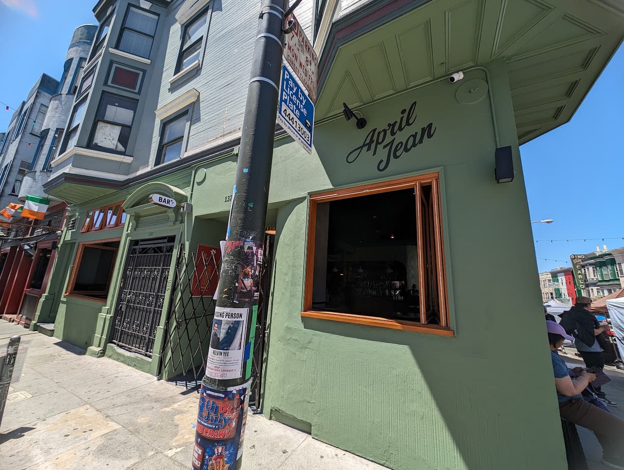 Exterior view of April Jean bar with green facade and open window. in San Francisco
