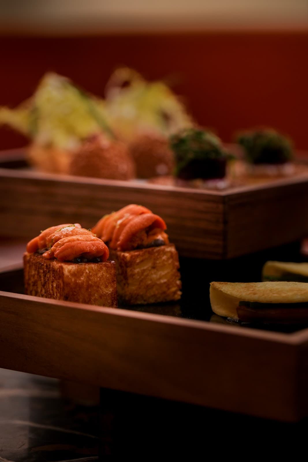 Close-up of gourmet appetizers on a wooden tray with blurred background in Toronto