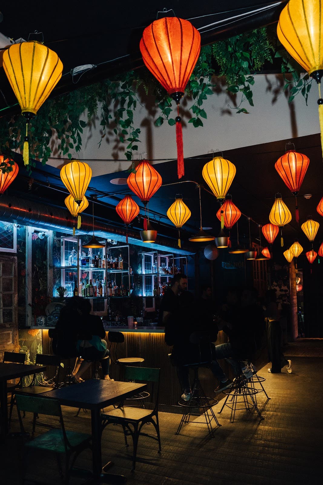 Moody bar interior with hanging lanterns and rustic decor in Toronto