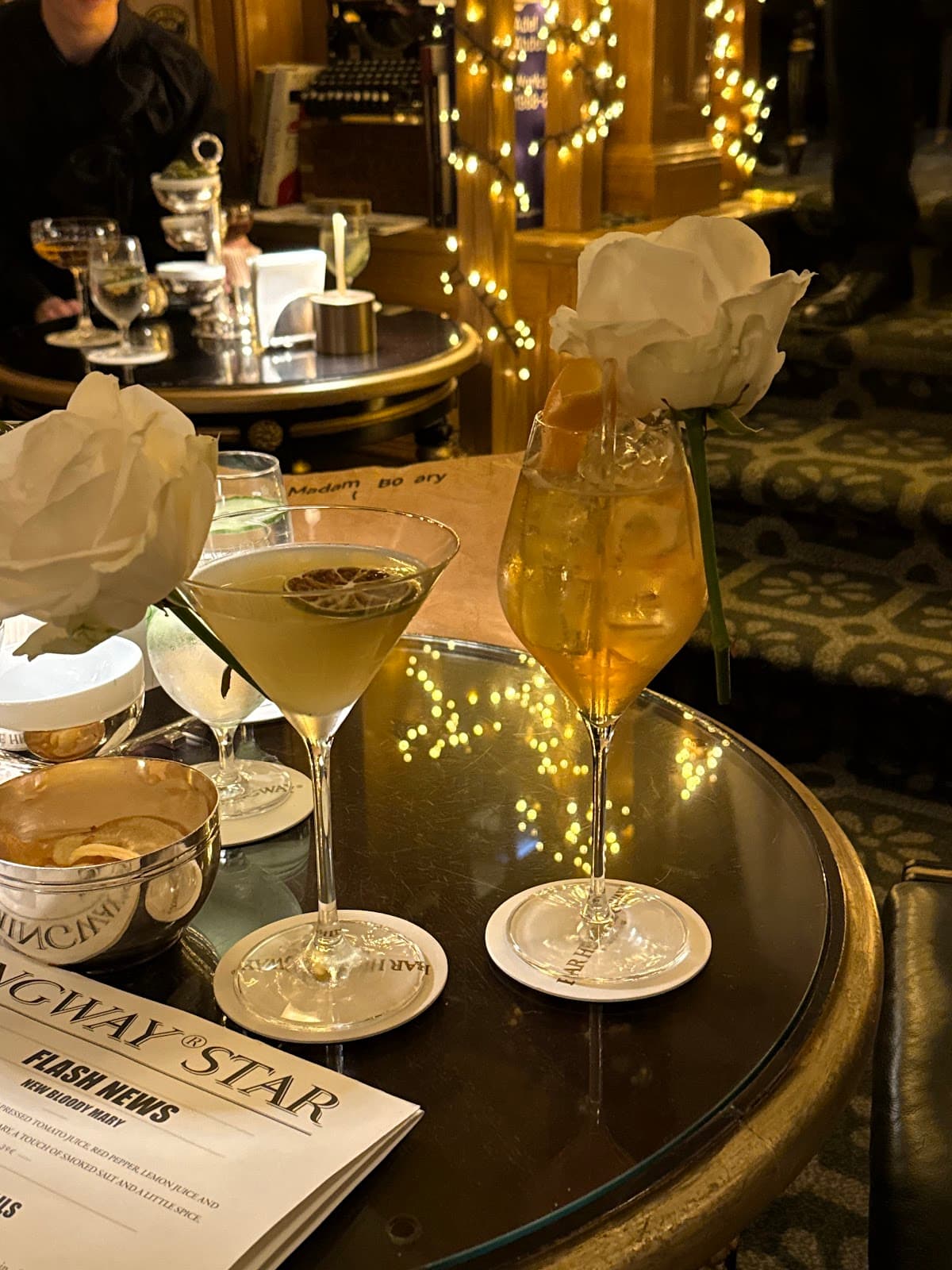 Elegant cocktail setup with drinks and roses on a table in Paris