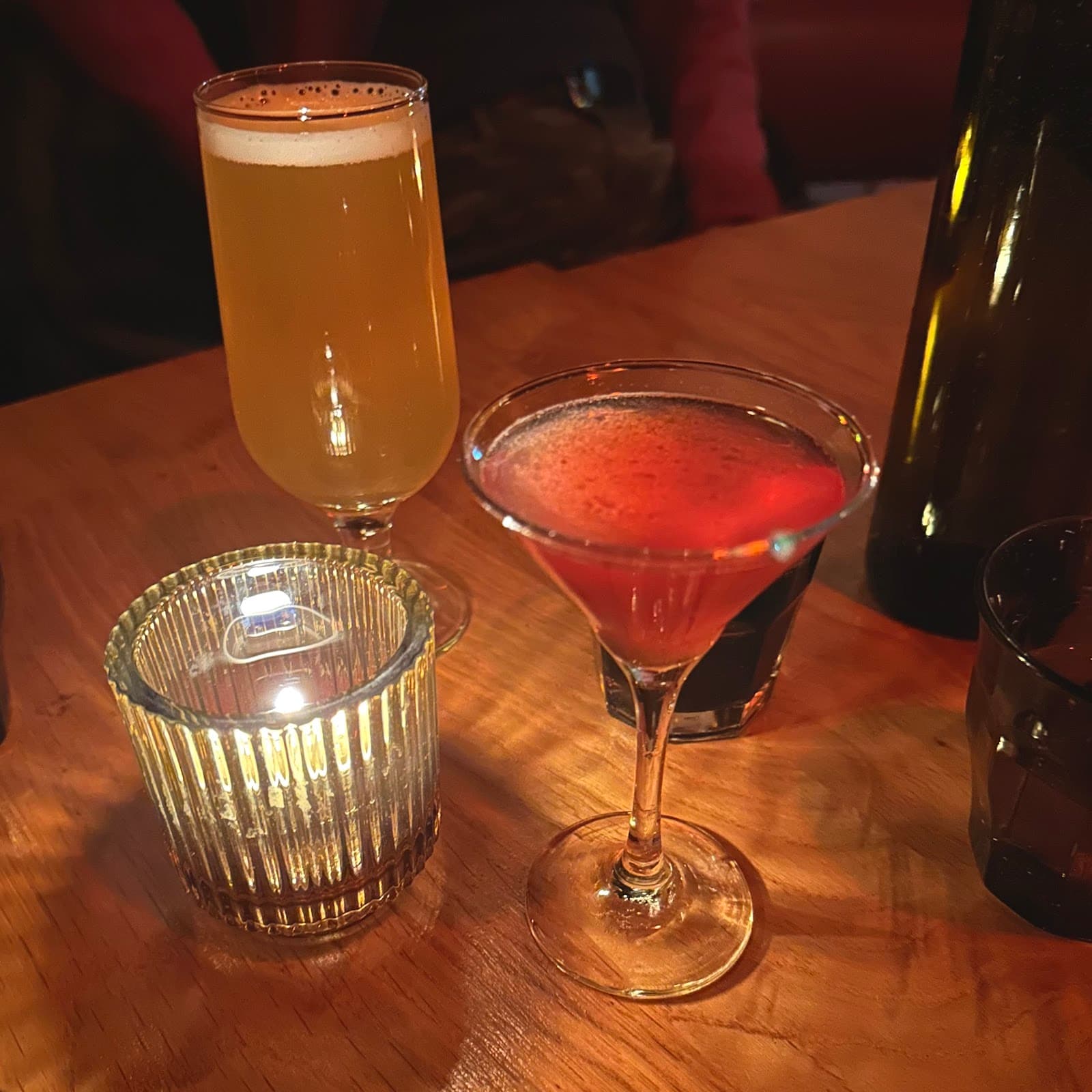 Close-up of cocktails on a wooden table with a candle in Toronto