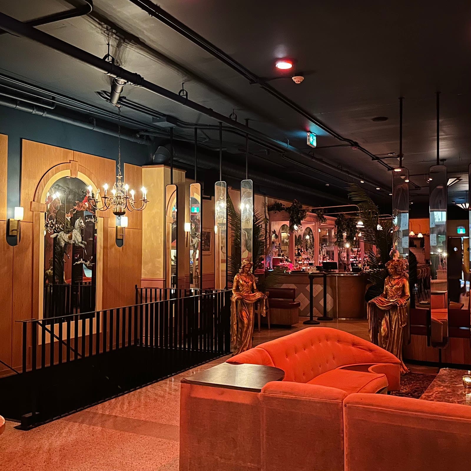 Stylish interior with orange seating and warm lighting in a premium cocktail bar in Toronto