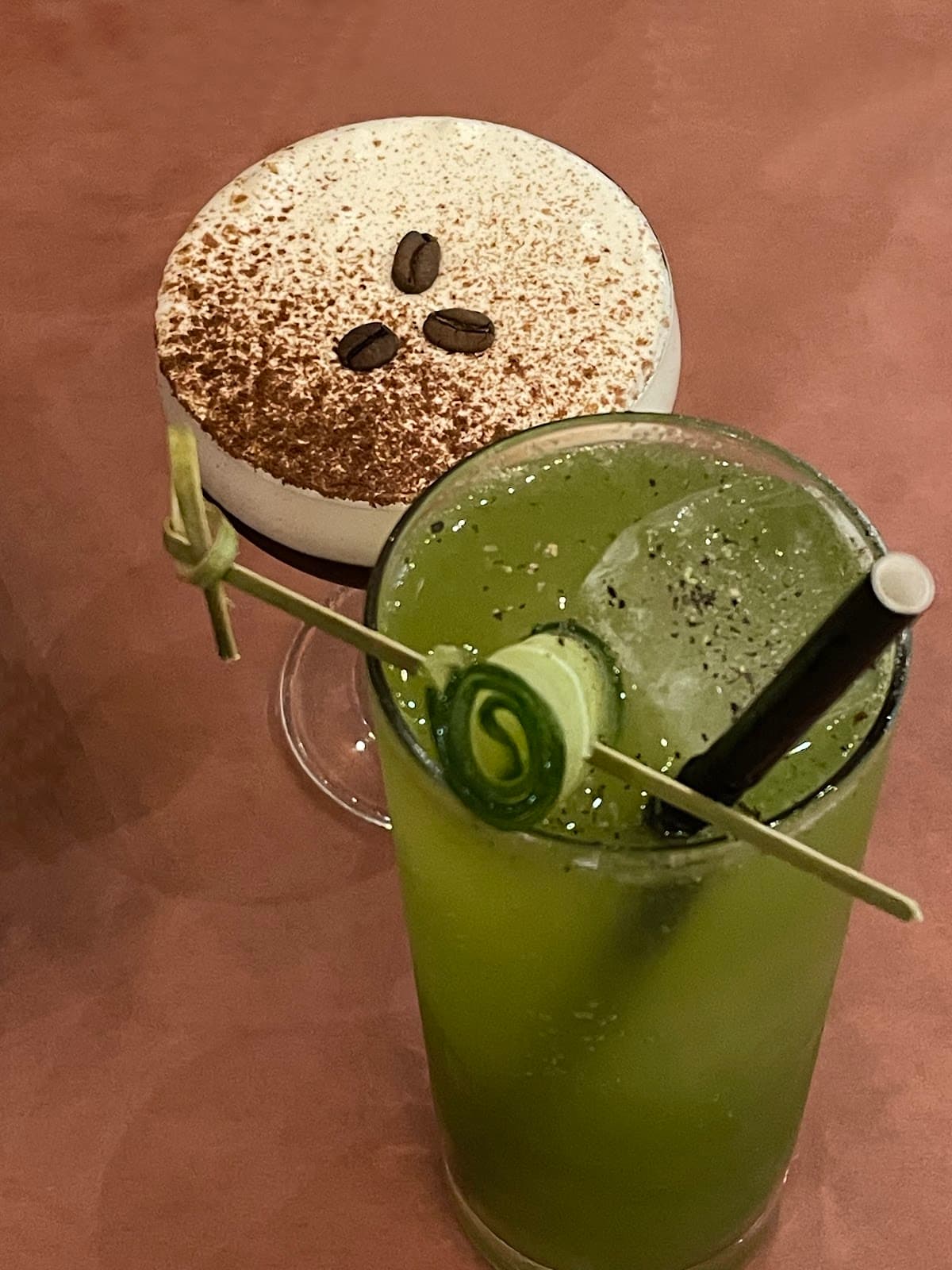 Close-up of a green cocktail and a creamy coffee cocktail on a table in Toronto