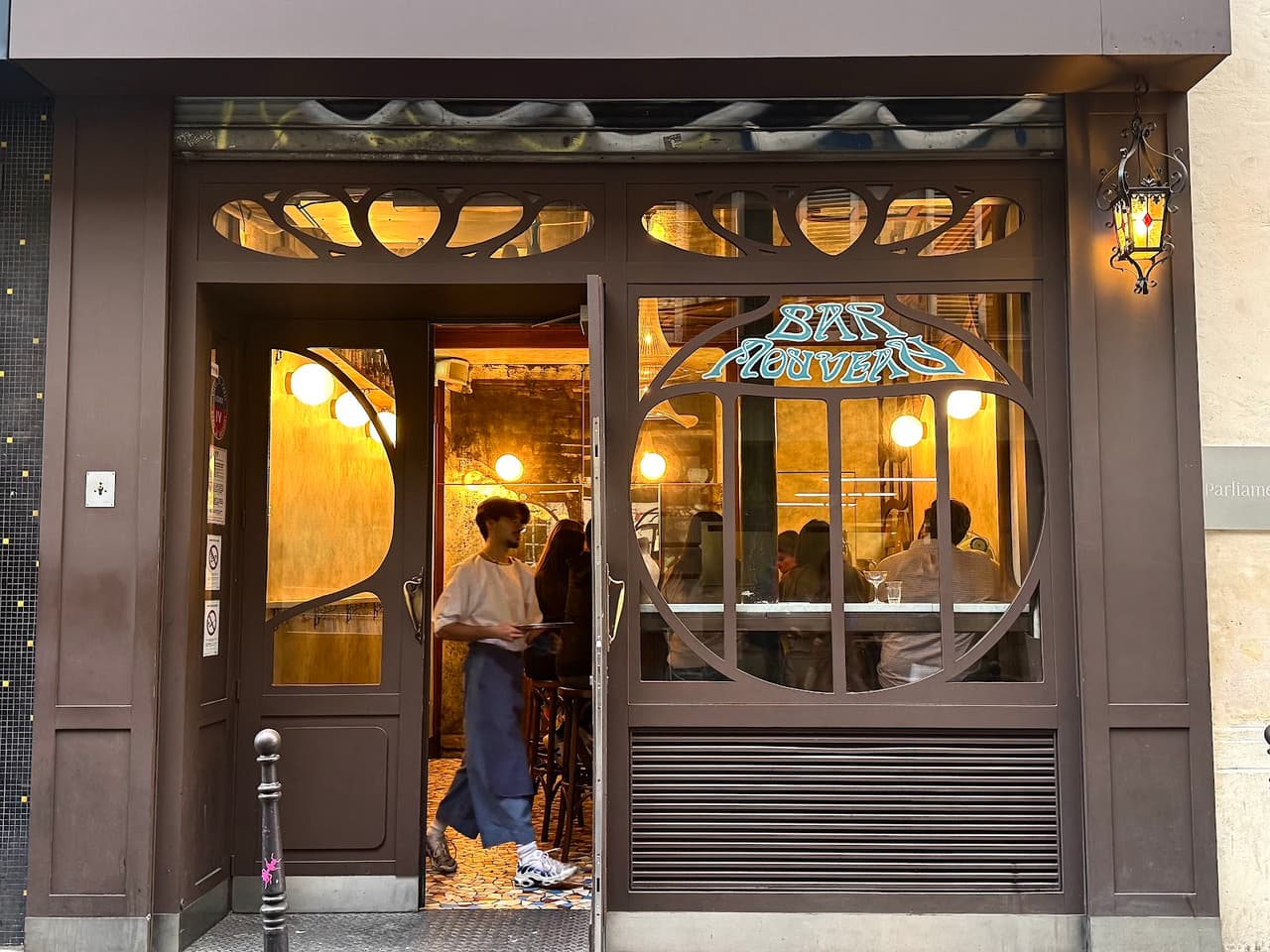 Exterior view of Bar Nouveau with entrance and warm lighting