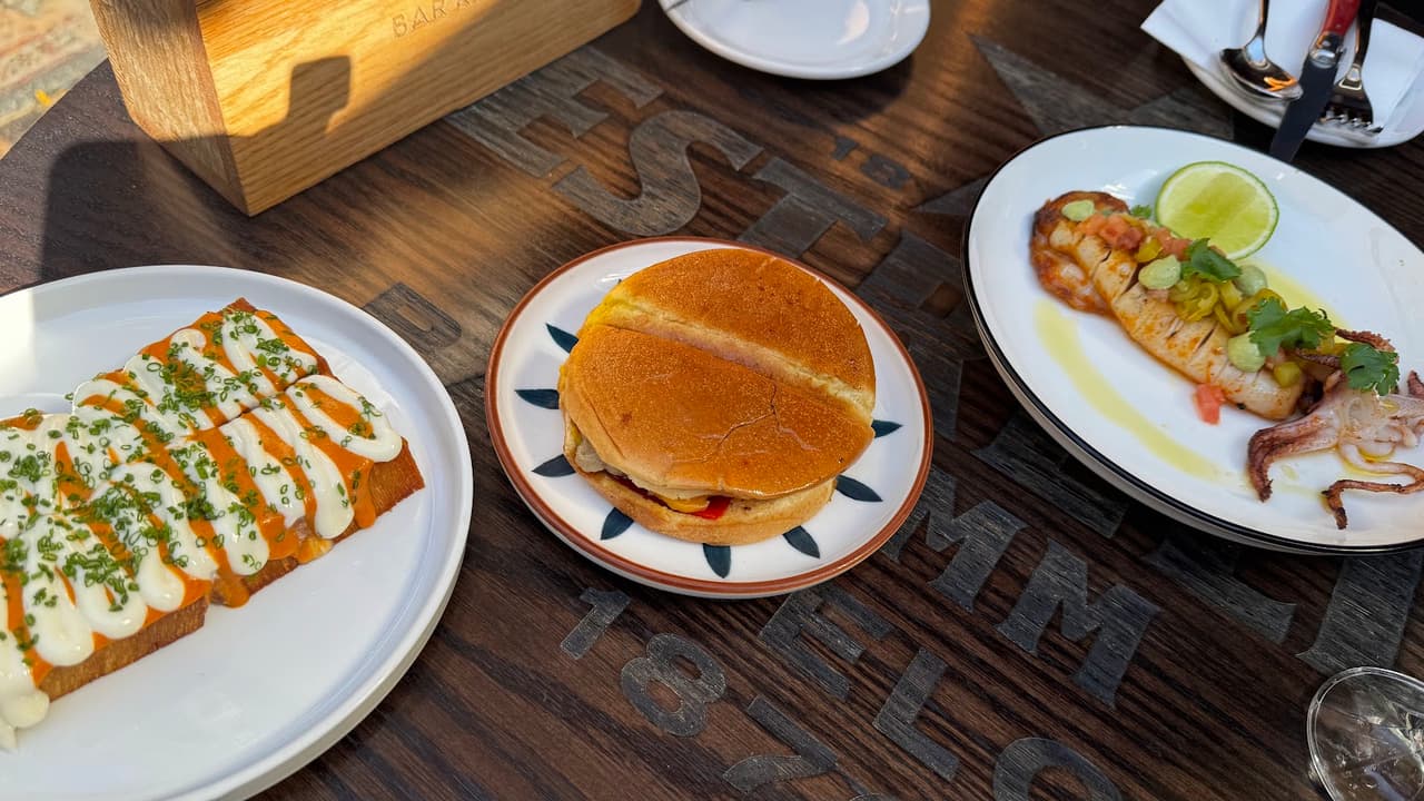 Plates of food on a wooden table at a restaurant in Toronto