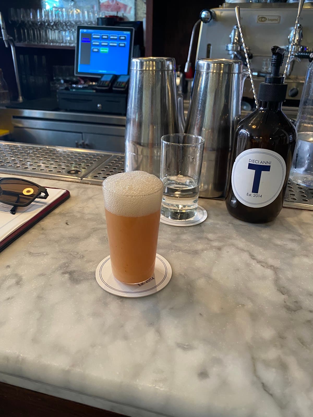 Marble bar counter with a cream cocktail and bar equipment in London