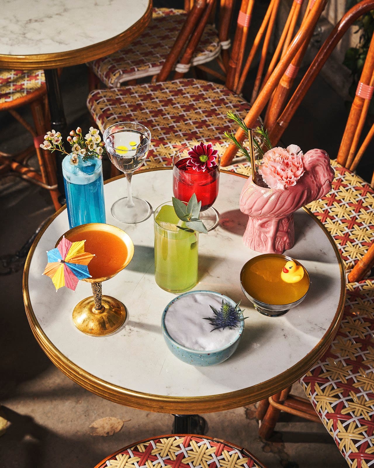 Variety of colorful cocktails on a marble table in a stylish setting in Paris