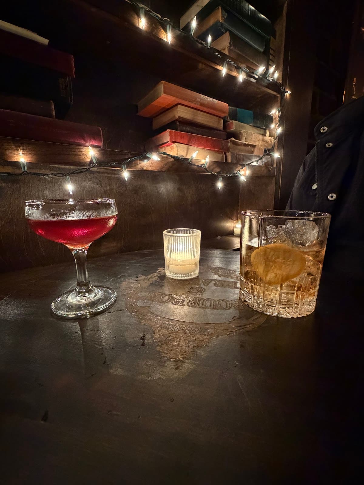 Cozy cocktail setting with drinks and candle on wooden table in San Francisco