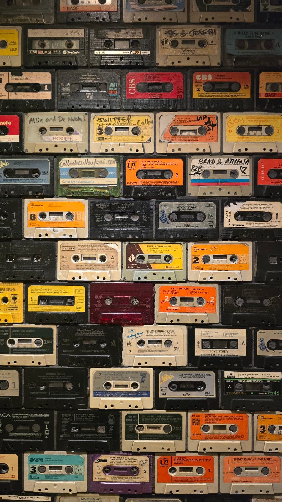 Wall decorated with vintage cassette tapes in various colors. in London