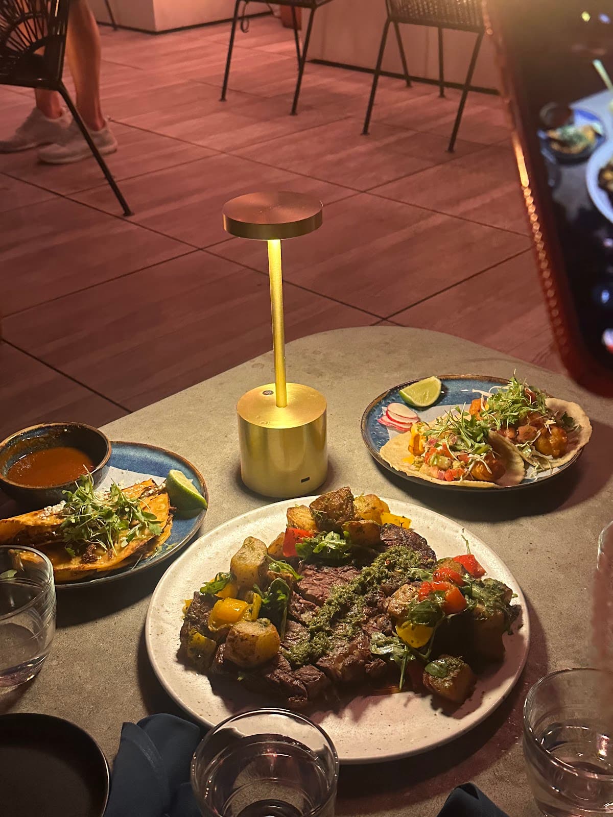 Outdoor dining table with dishes and ambient lighting in San Francisco