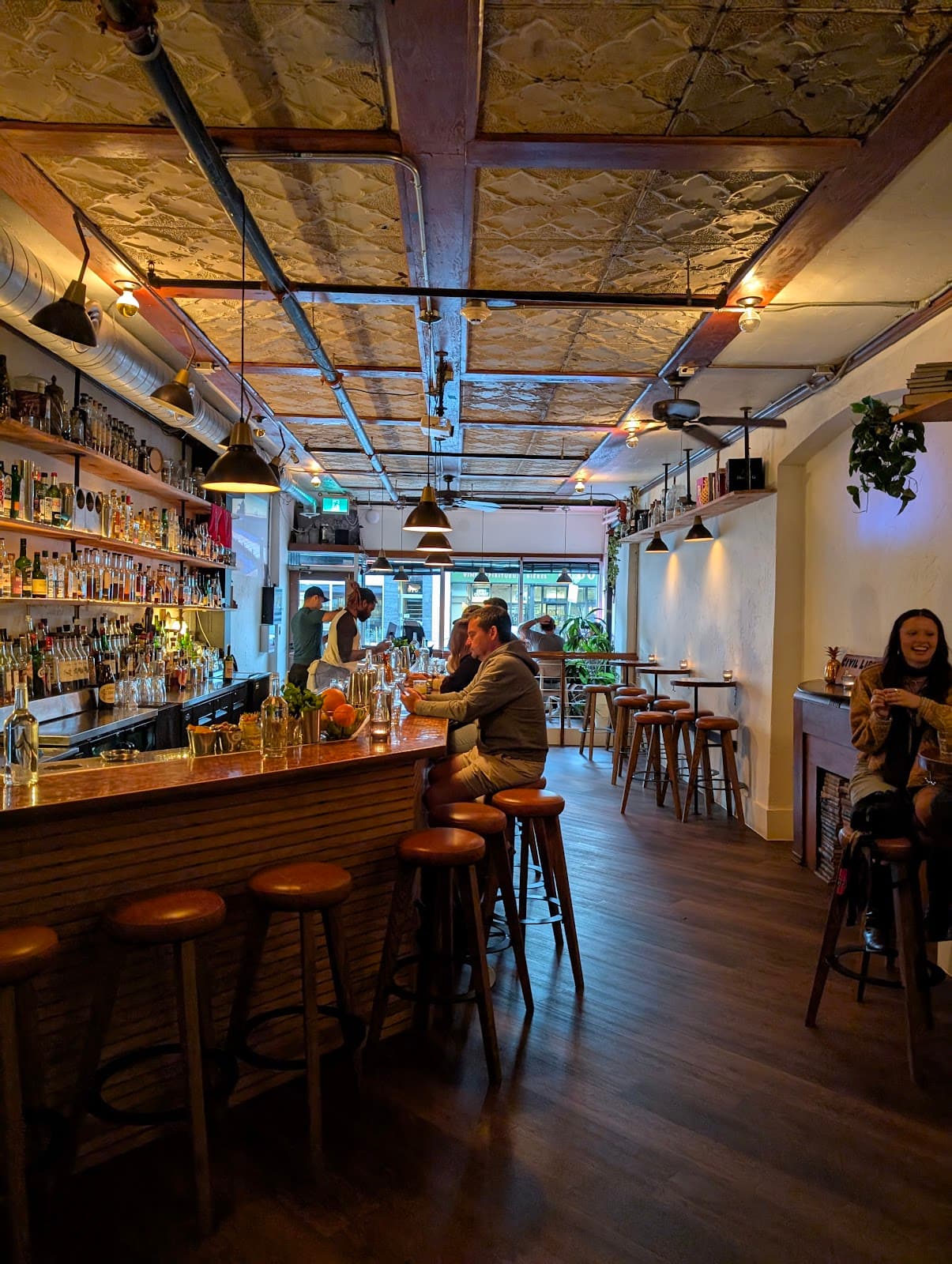 Cozy bar interior with wooden stools and warm lighting in Toronto