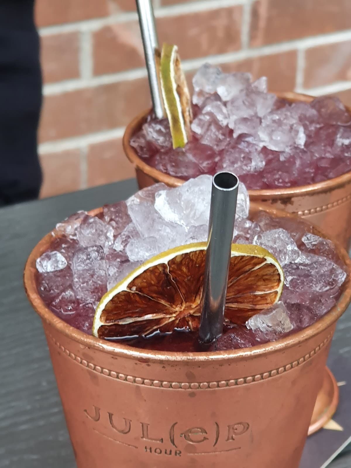Cocktail in a copper mug with ice and garnished with dried citrus in Toronto