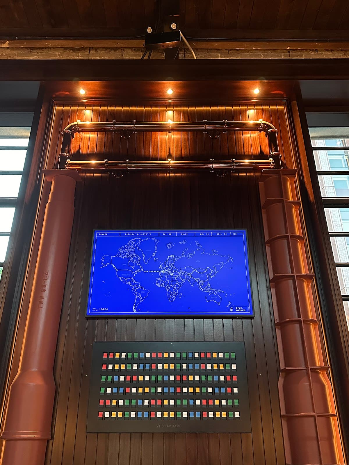 Interior wall with world map display and colorful panel in a cocktail bar in Toronto