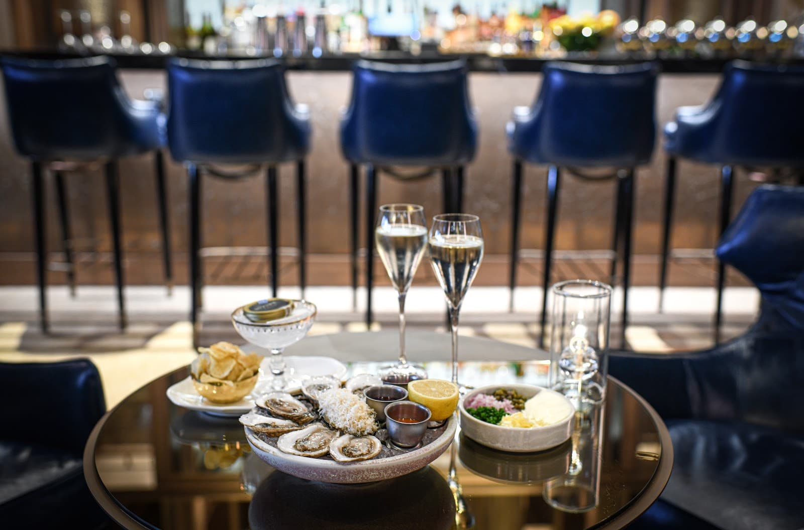 Luxurious bar scene with oysters, champagne, and leather barstools in Toronto