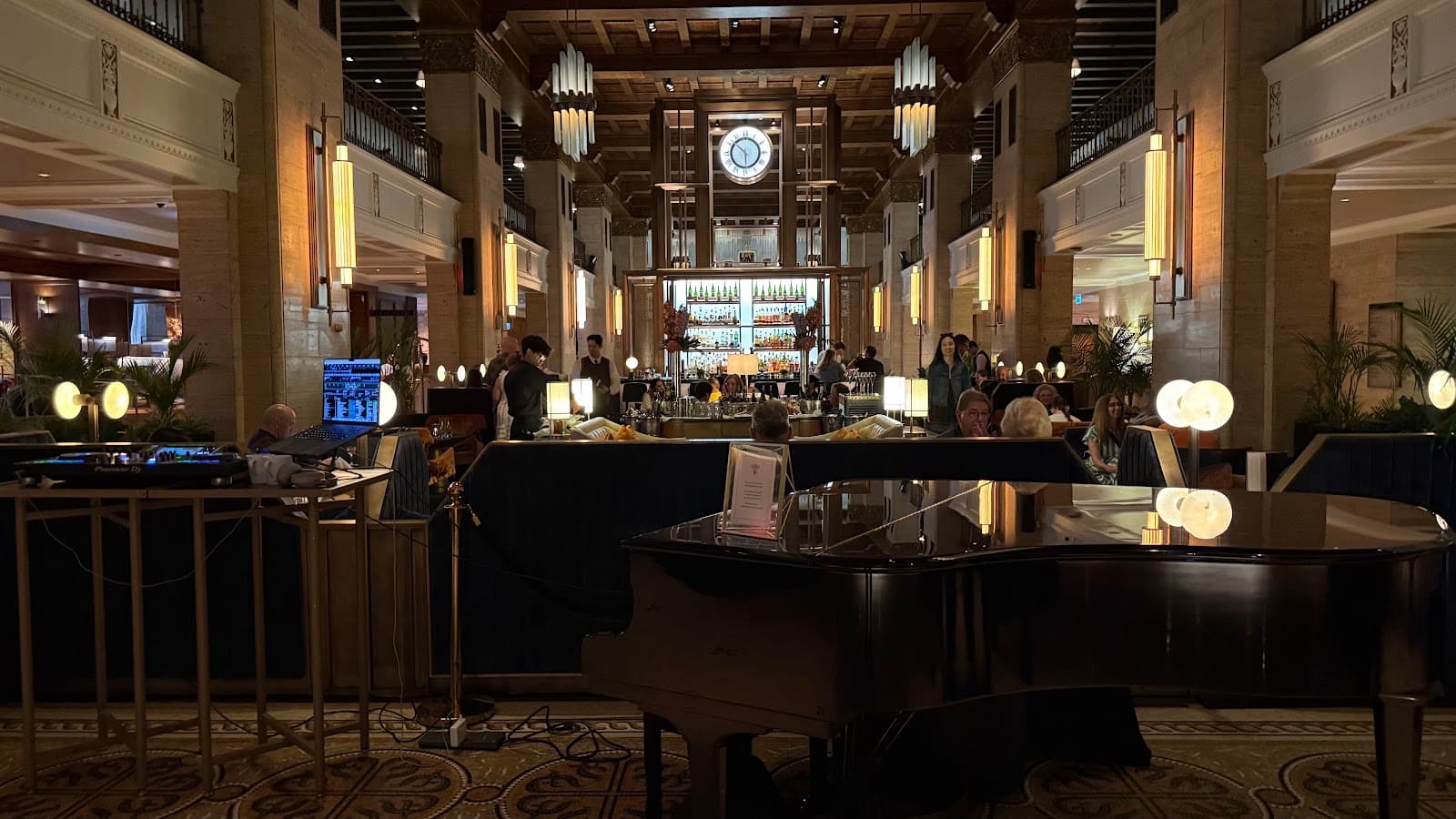 Luxurious interior with grand piano, high ceiling, and illuminated bar counter in Toronto