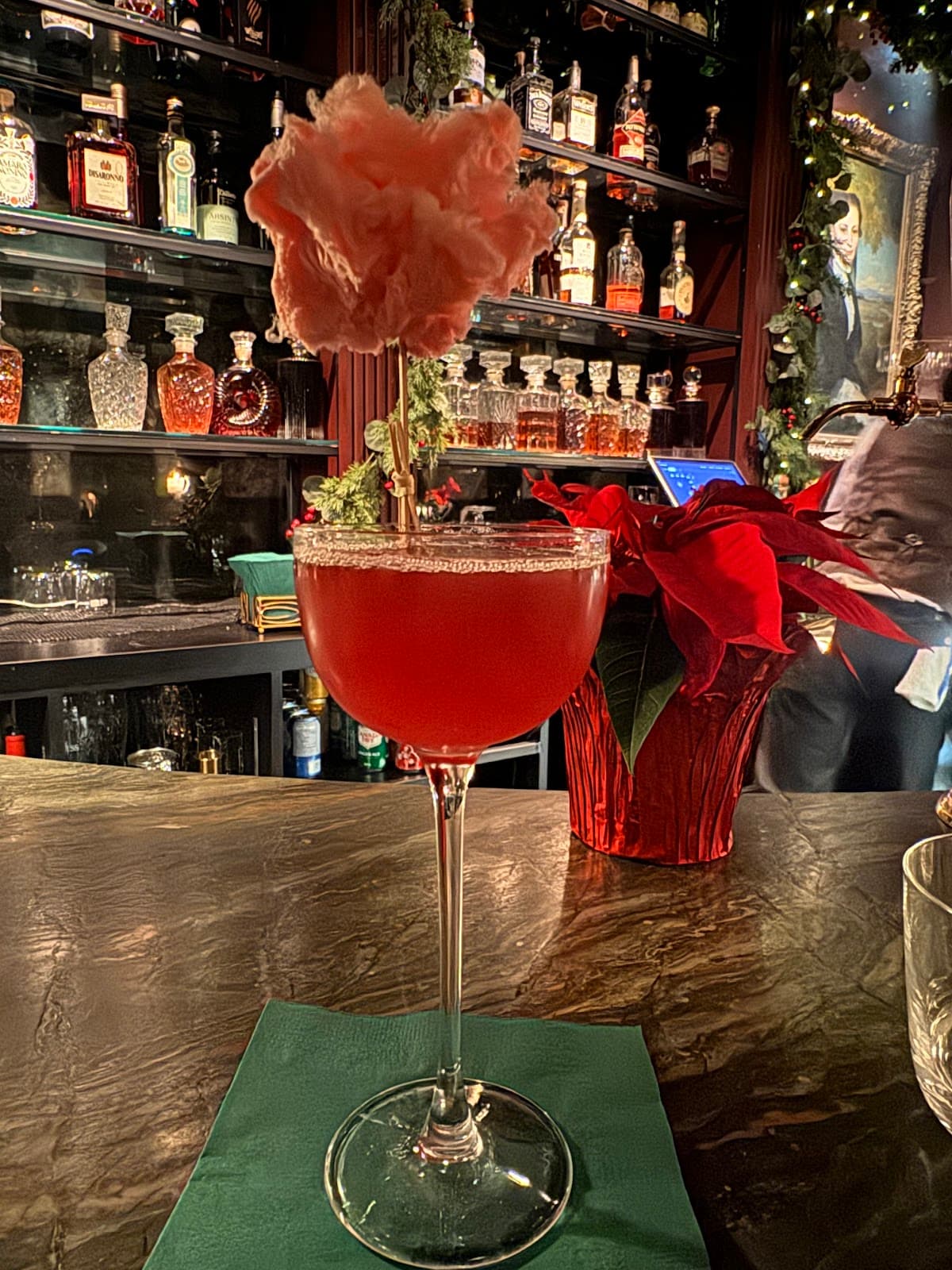 Craft cocktail with pink garnish in an elegant bar setting in Toronto