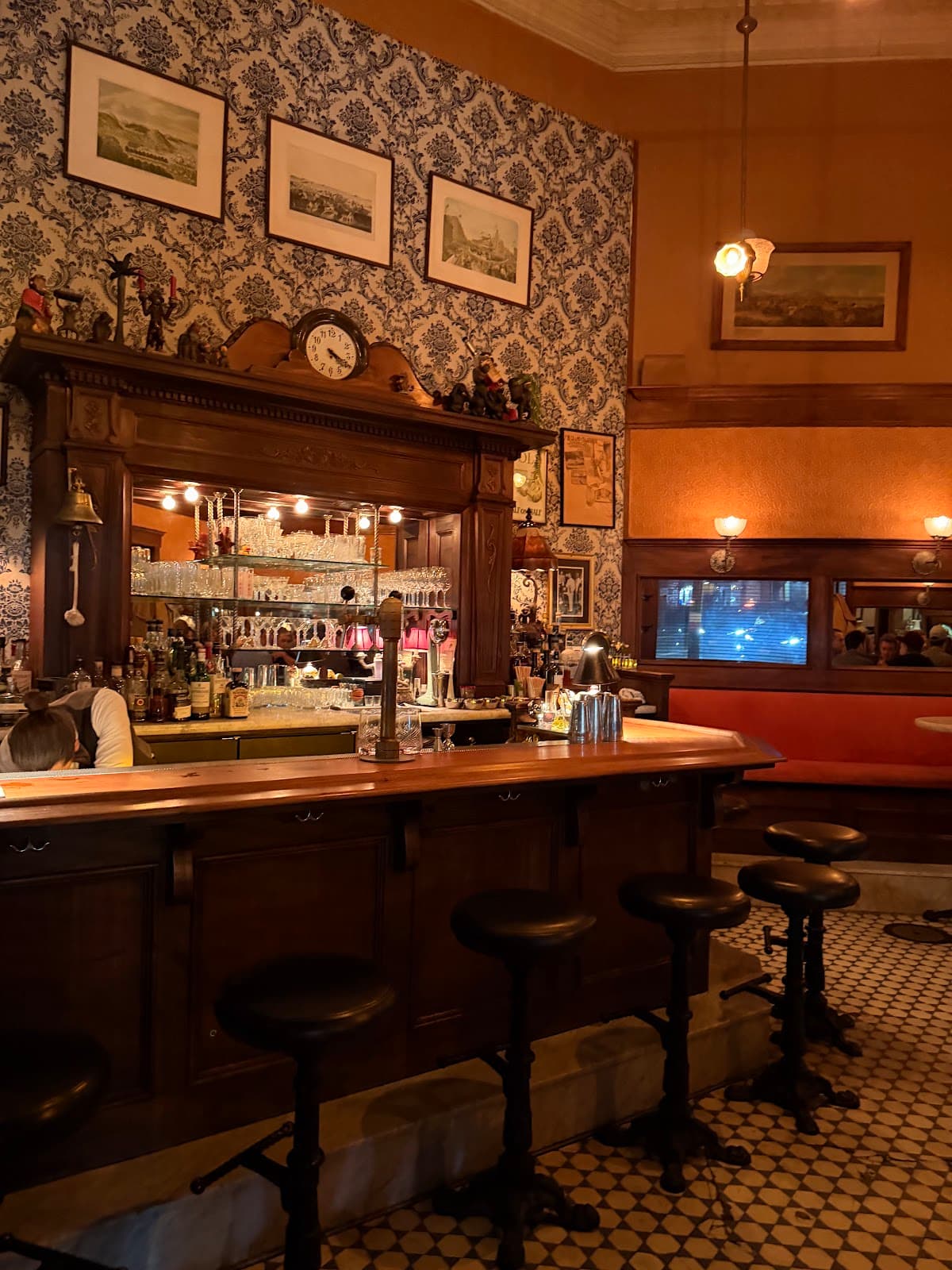 Vintage-style bar with patterned wallpaper and stools in San Francisco