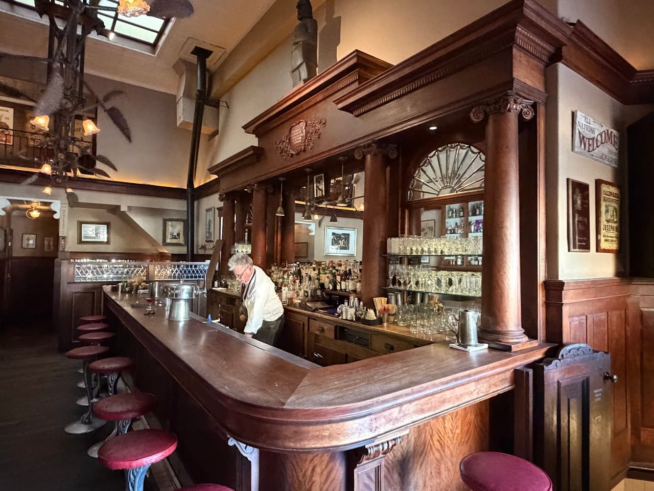 Elegant bar counter with wooden decor and bartender in a classic setting in San Francisco