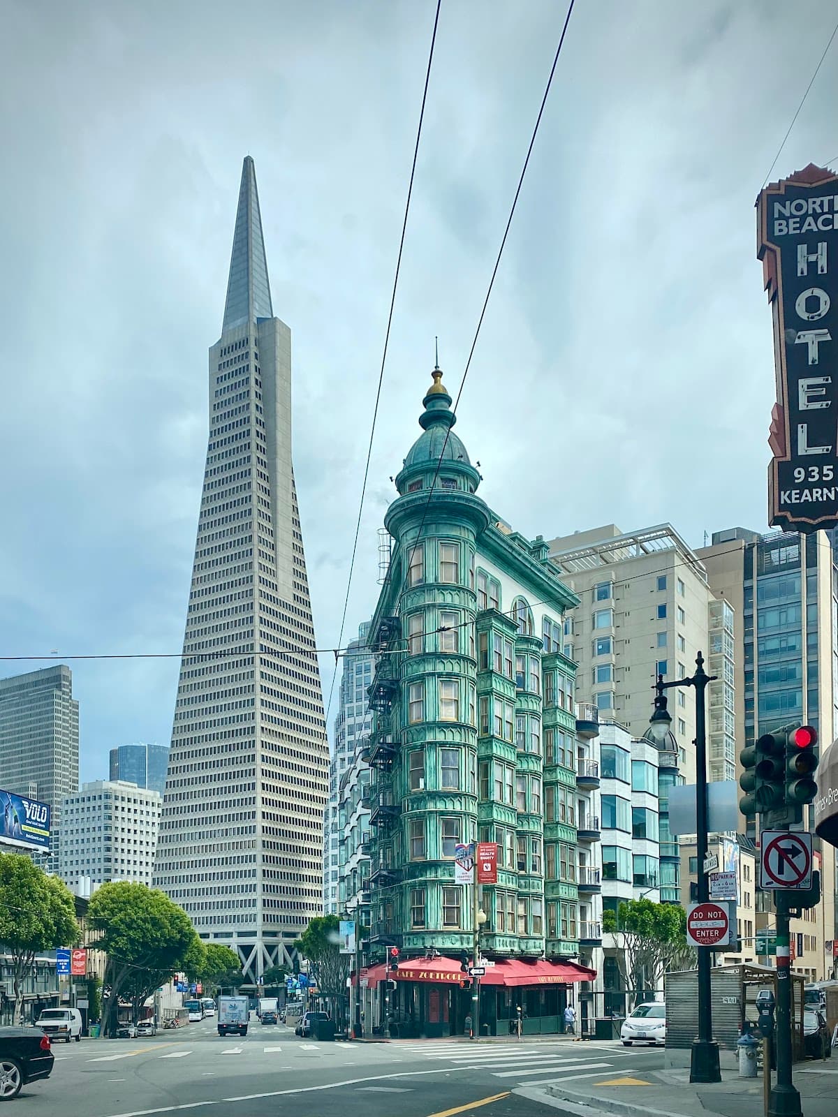 Distinctive green building with red awnings on a city street corner in San Francisco