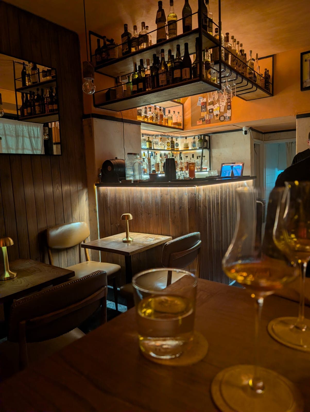 Cozy cocktail bar interior with dim lighting and wooden decor
