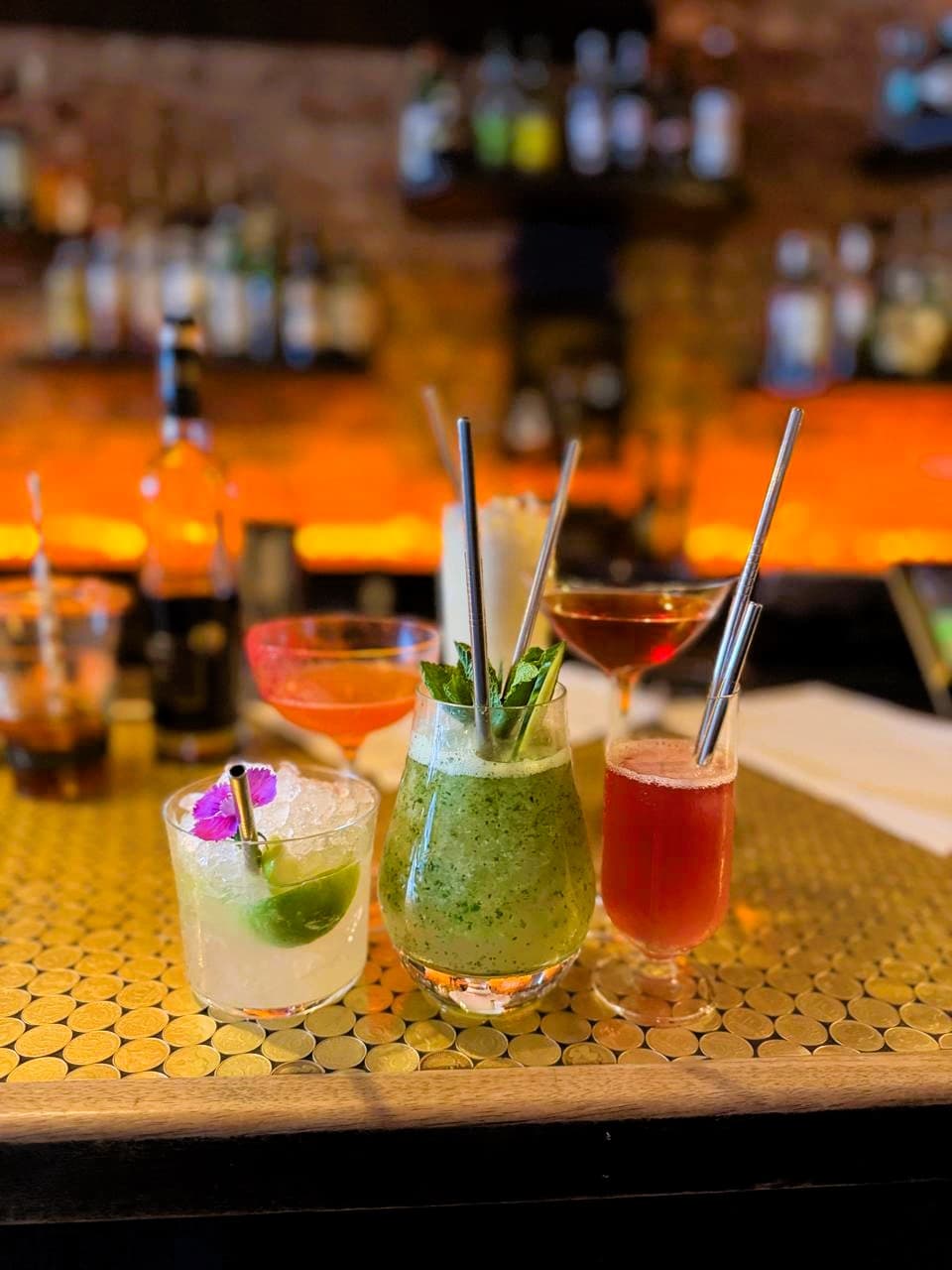 Assorted cocktails on a bar counter with blurred background in London