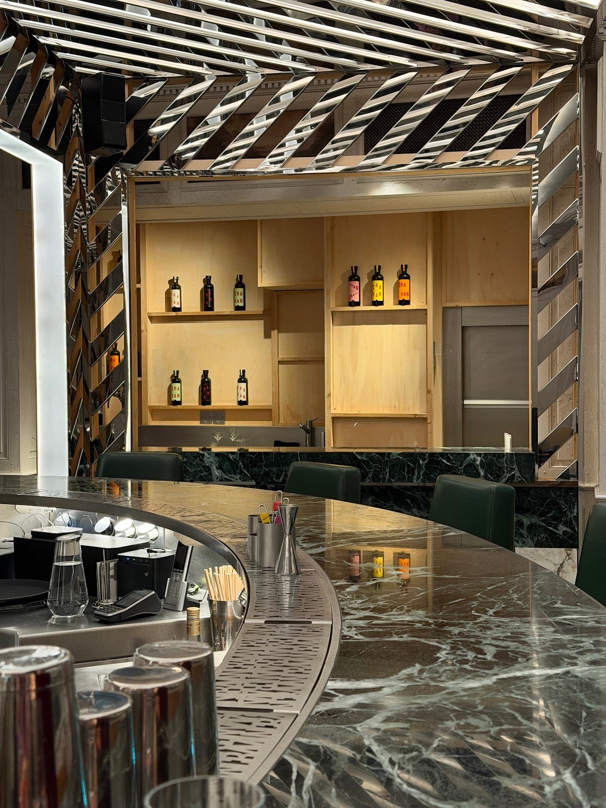 Stylish bar with marble countertop and shelved bottles in a modern setting in Paris