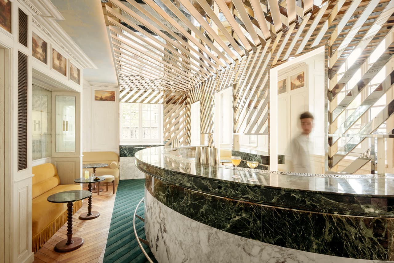 Elegant bar interior with marble counter and unique ceiling design