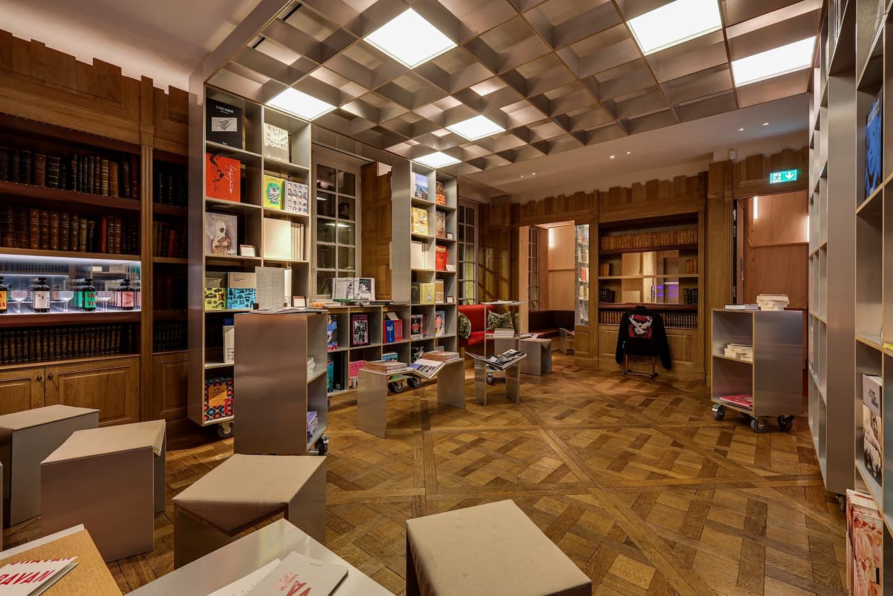 Stylish interior with wooden bookshelves and modern seating arrangements in Paris