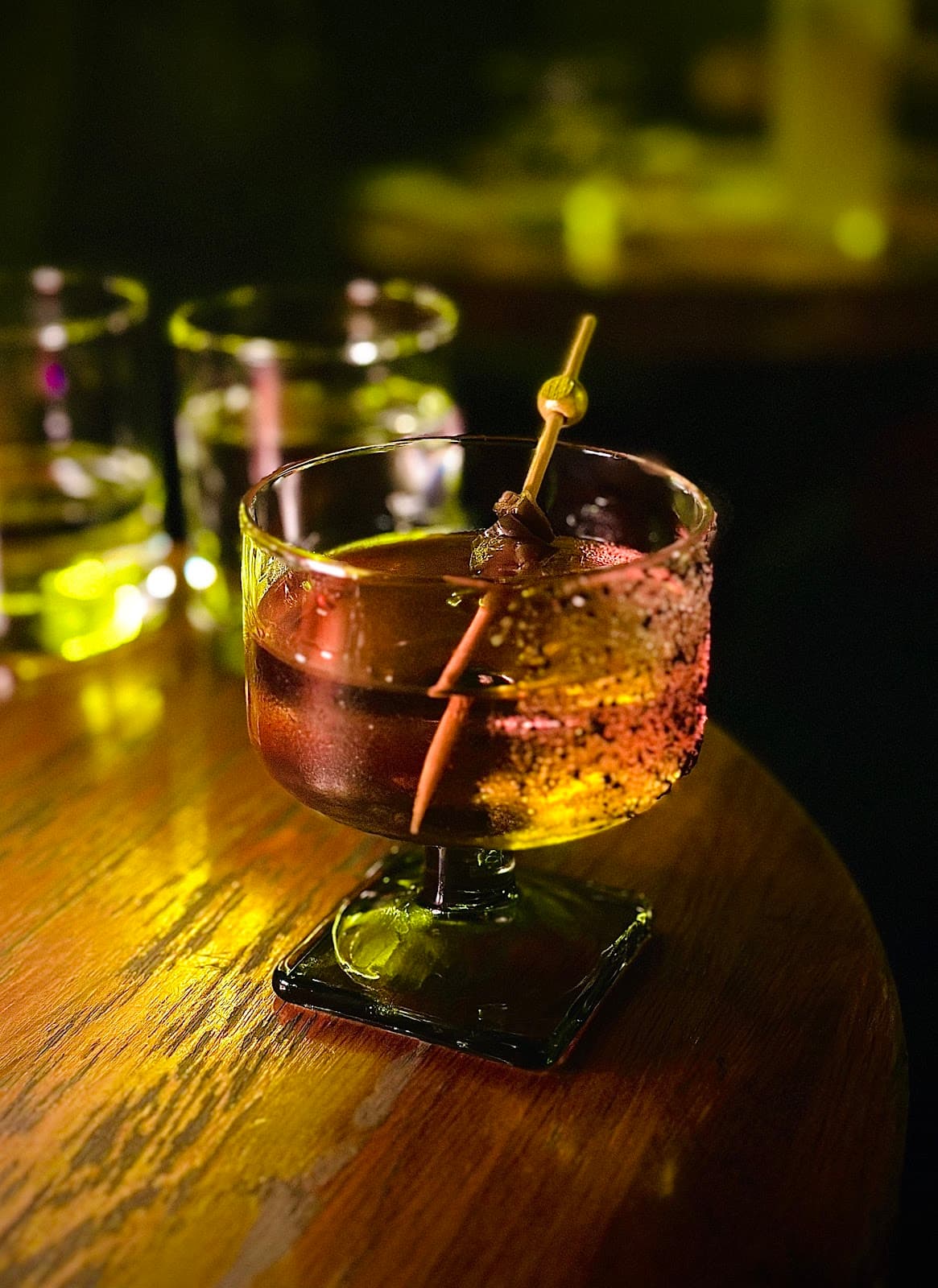 Close-up of a cocktail with garnish on a wooden table in Toronto