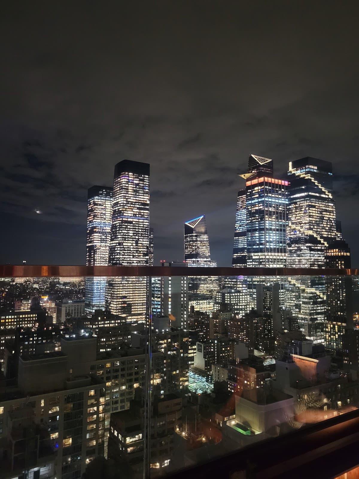 Rooftop view of illuminated city skyline at night in New York