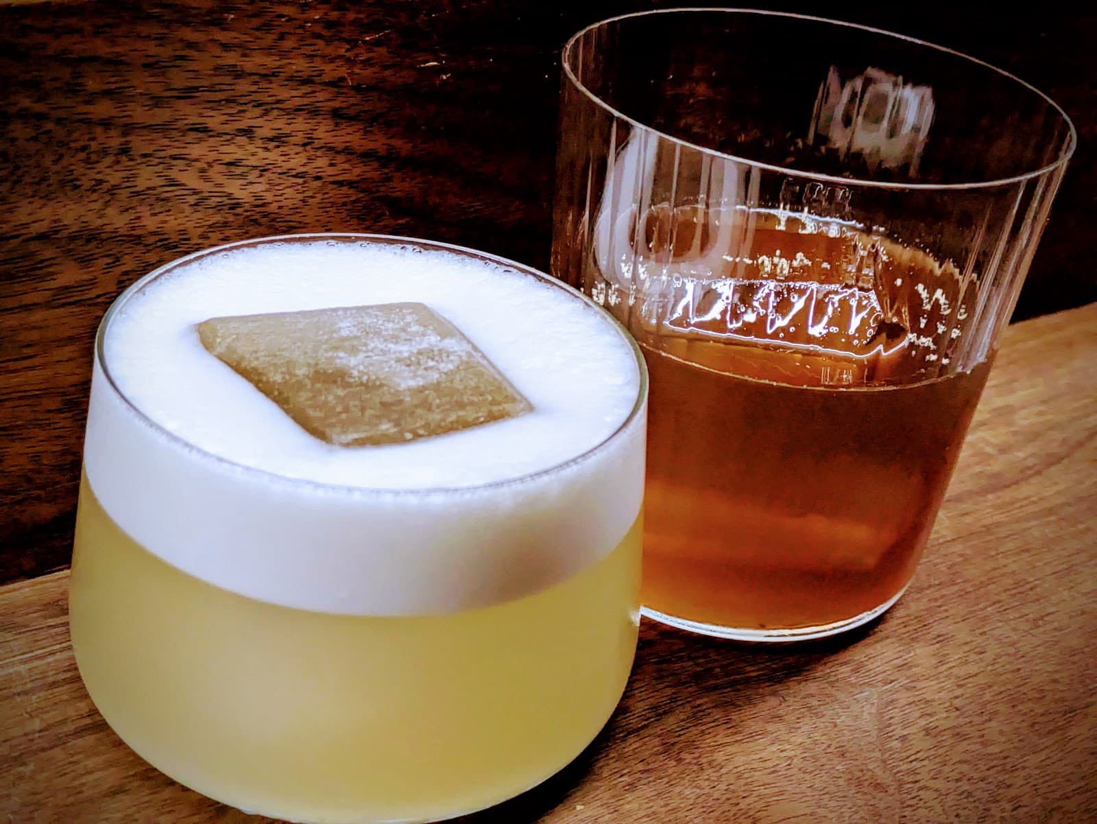 Close-up of two stylish cocktails on a wooden counter in New York