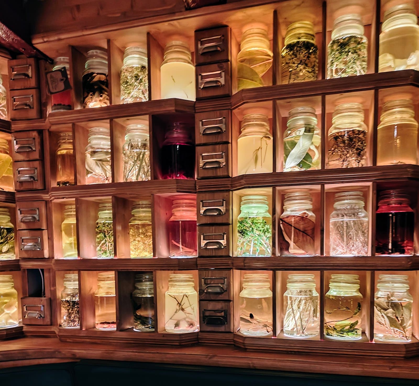 Display of illuminated jars with herbs at a bar in Barcelona