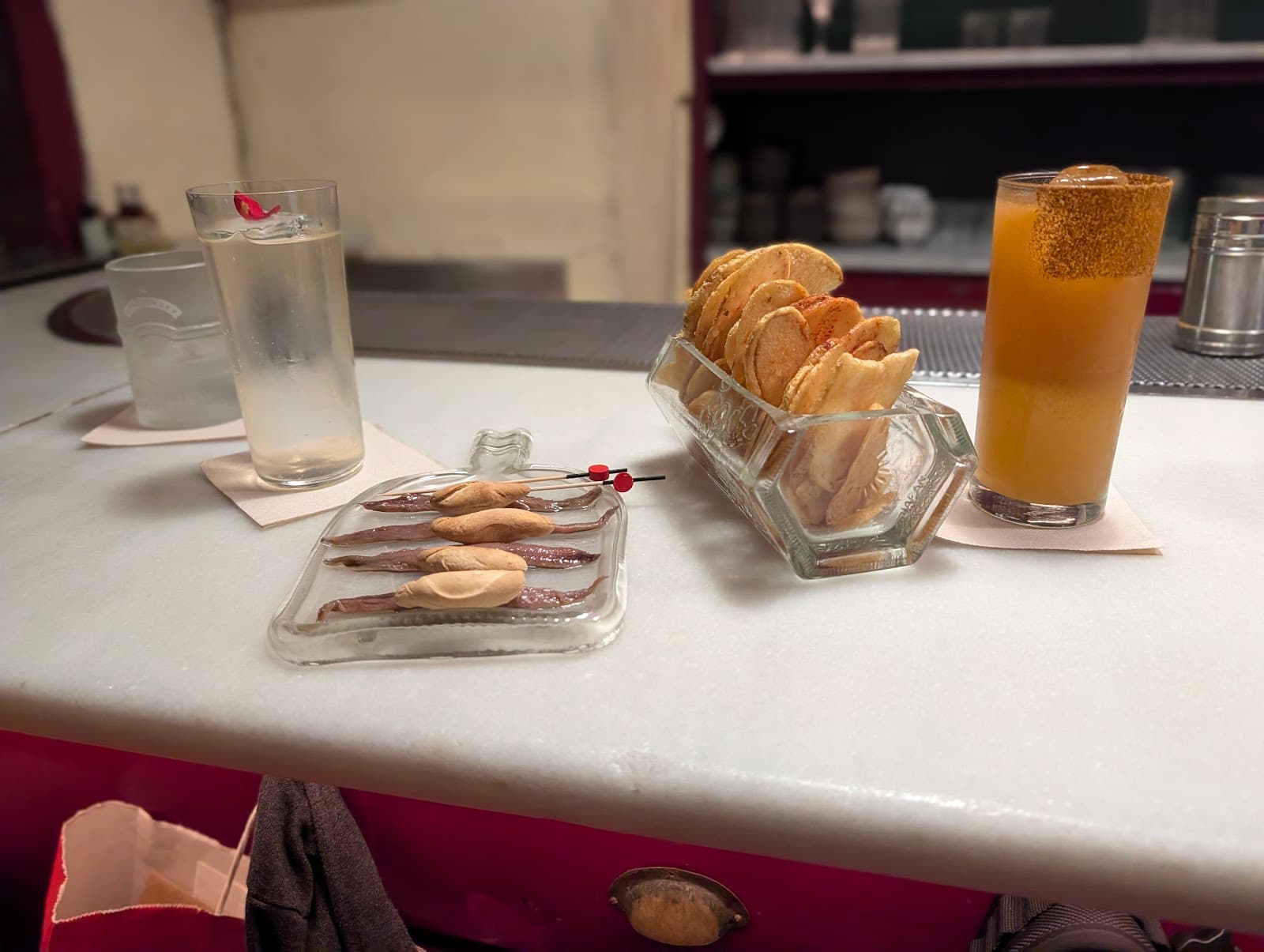 Cocktail glasses on a bar with snacks in a premium setting in Barcelona