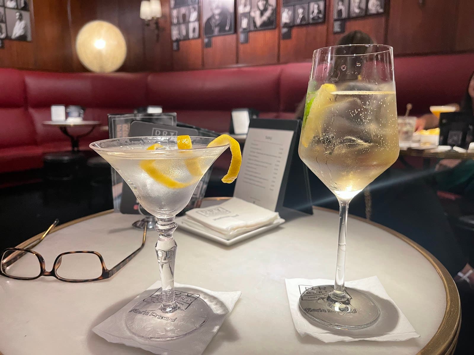 Two cocktails on a table in a dimly lit bar interior in Barcelona