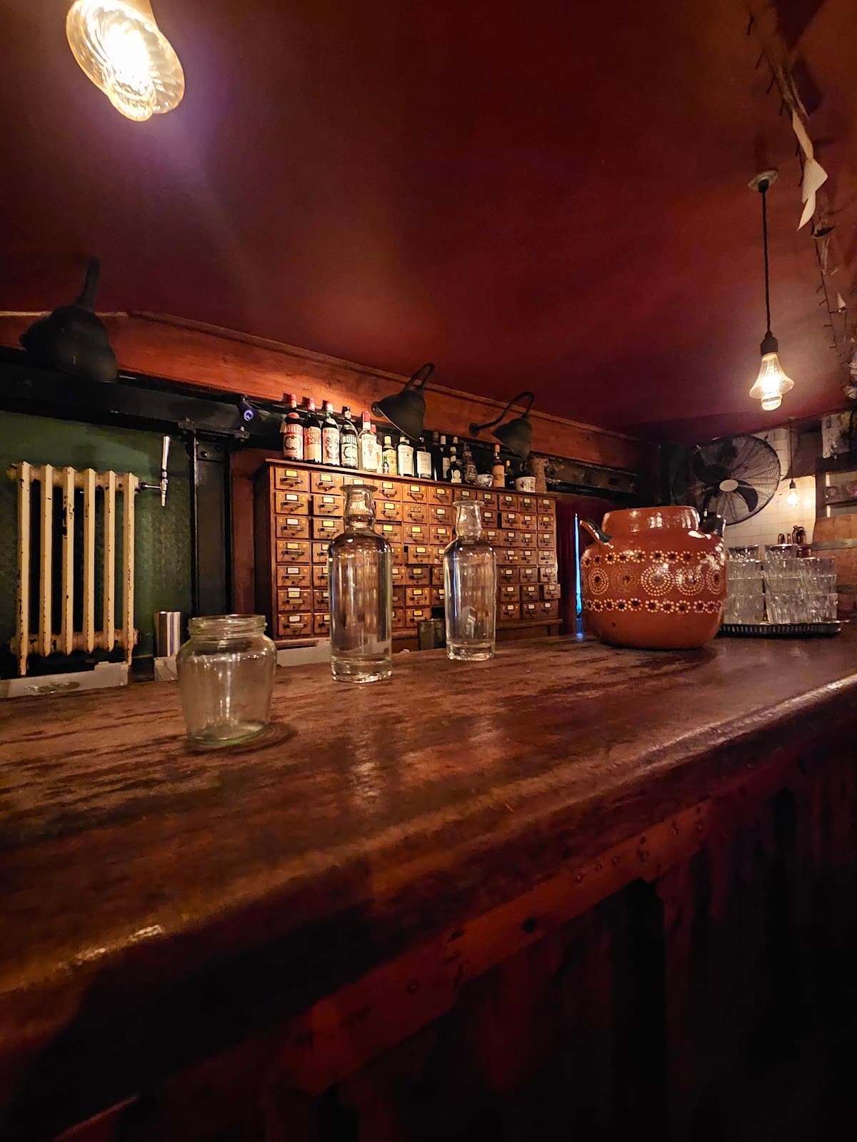 Rustic bar counter with bottles and jars on display